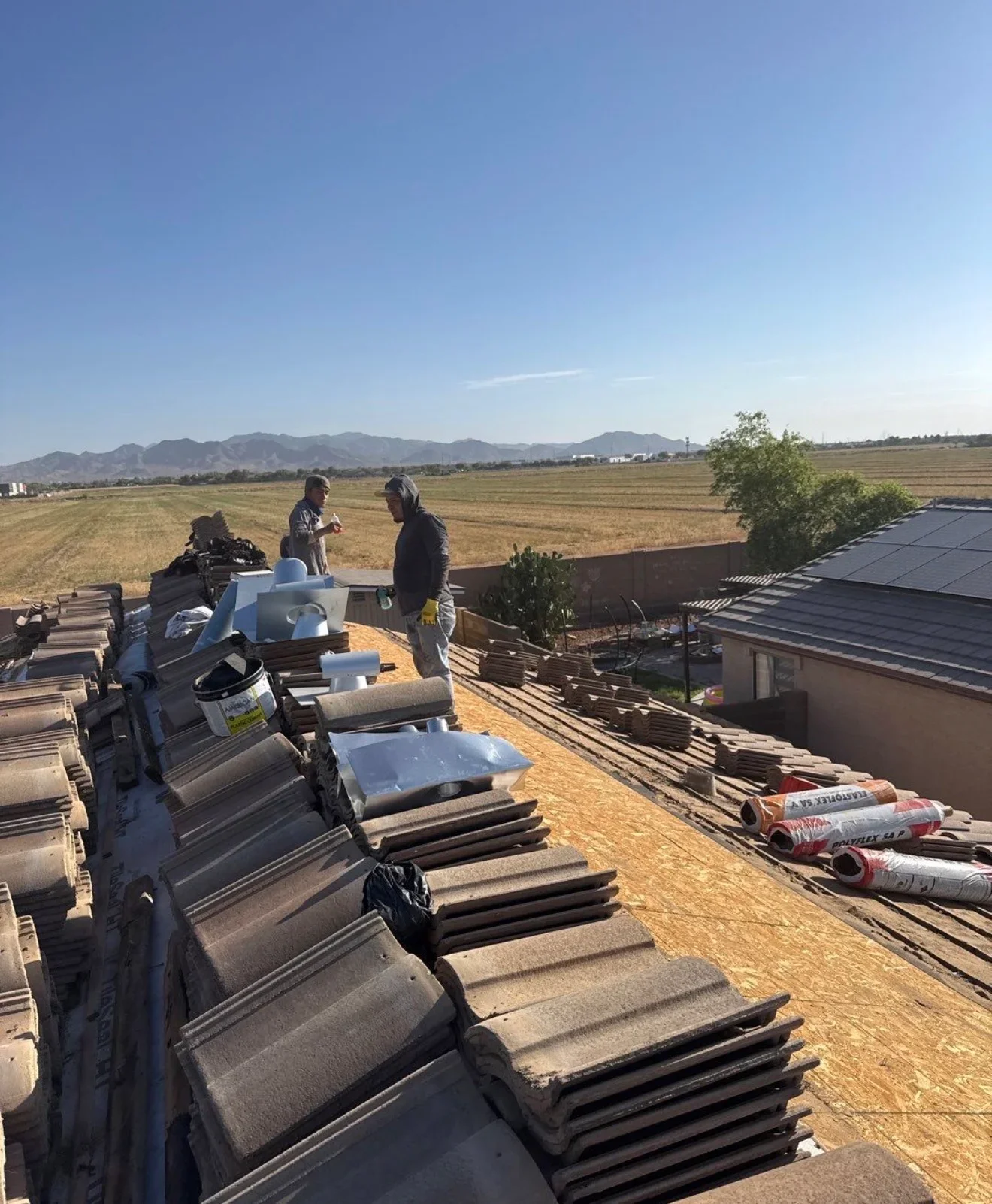 Concrete tile roofing materials staged on roof during residential replacement installation
