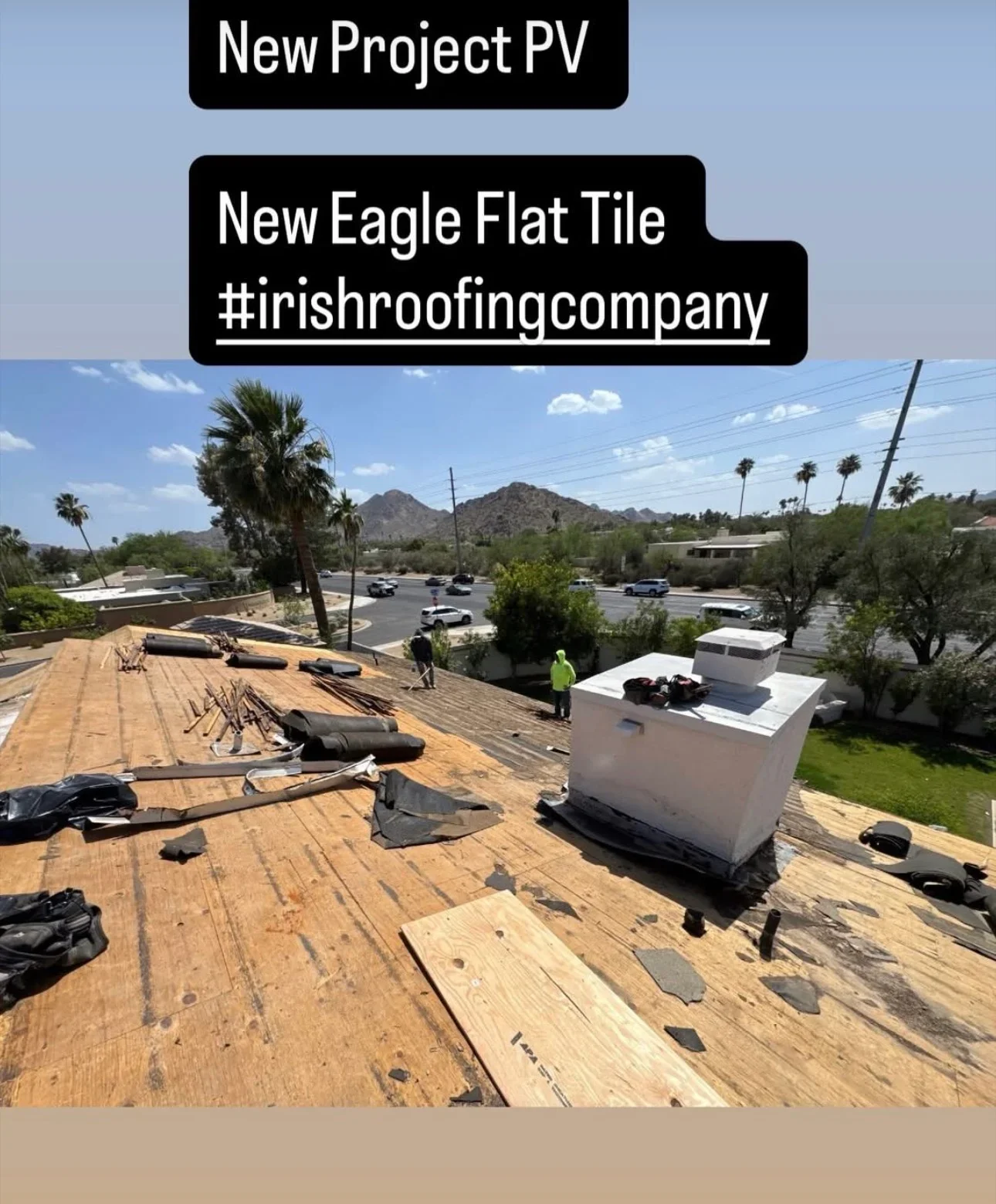 Flat roof installation with wooden decking and new white Eagle tile sections during active construction
