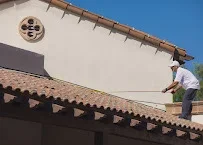 Decorative timber soffit, fascia, and corbel brackets installed along roofline with clear blue sky