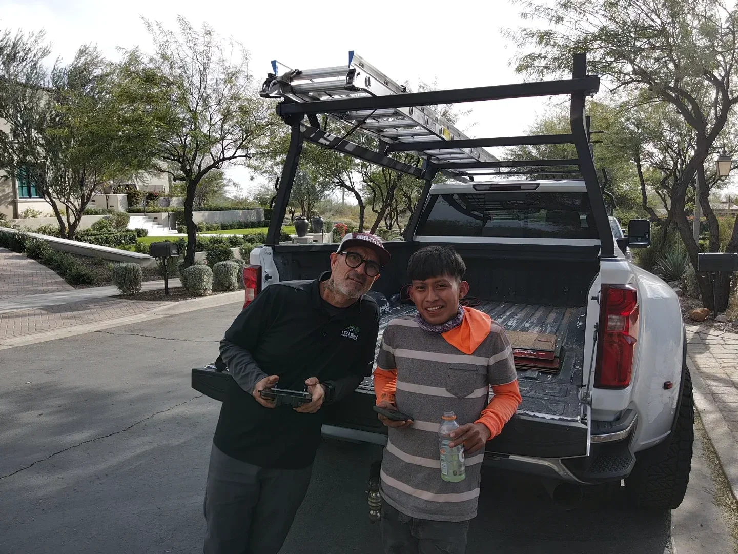 Black steel truck rack with load bars mounted on white pickup truck bed