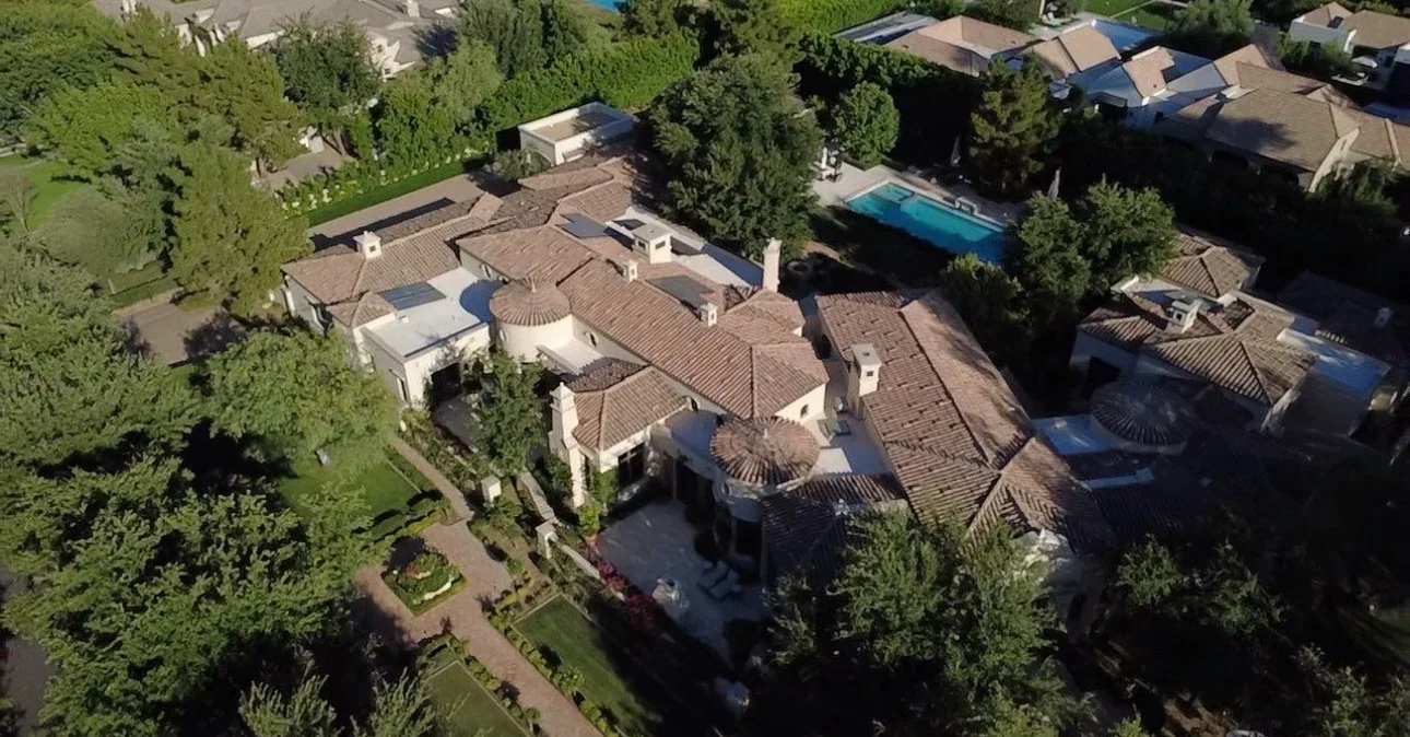 Aerial view of residential roof with clay barrel tiles, multiple sections, and curved architectural details