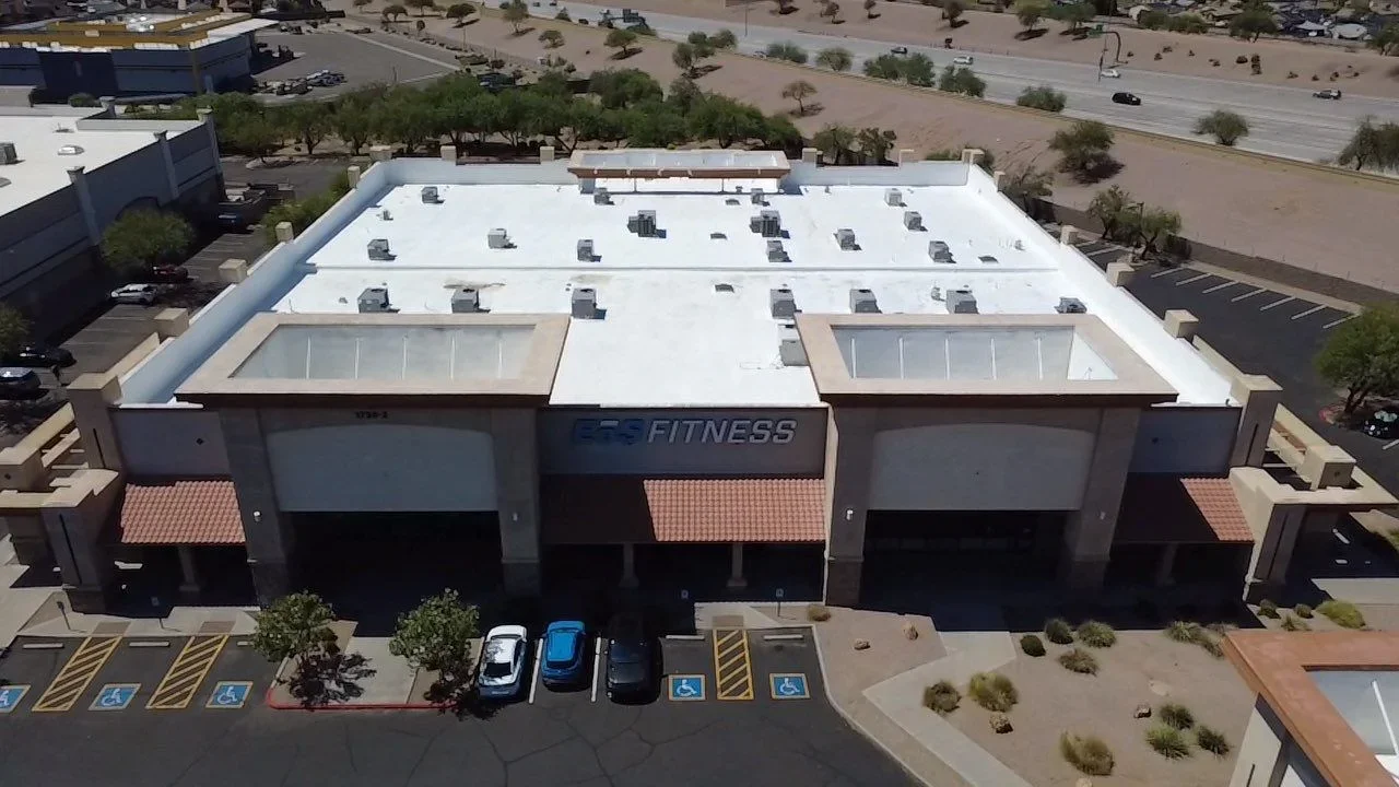 White TPO flat roof with HVAC units and aluminum edge trim on commercial building