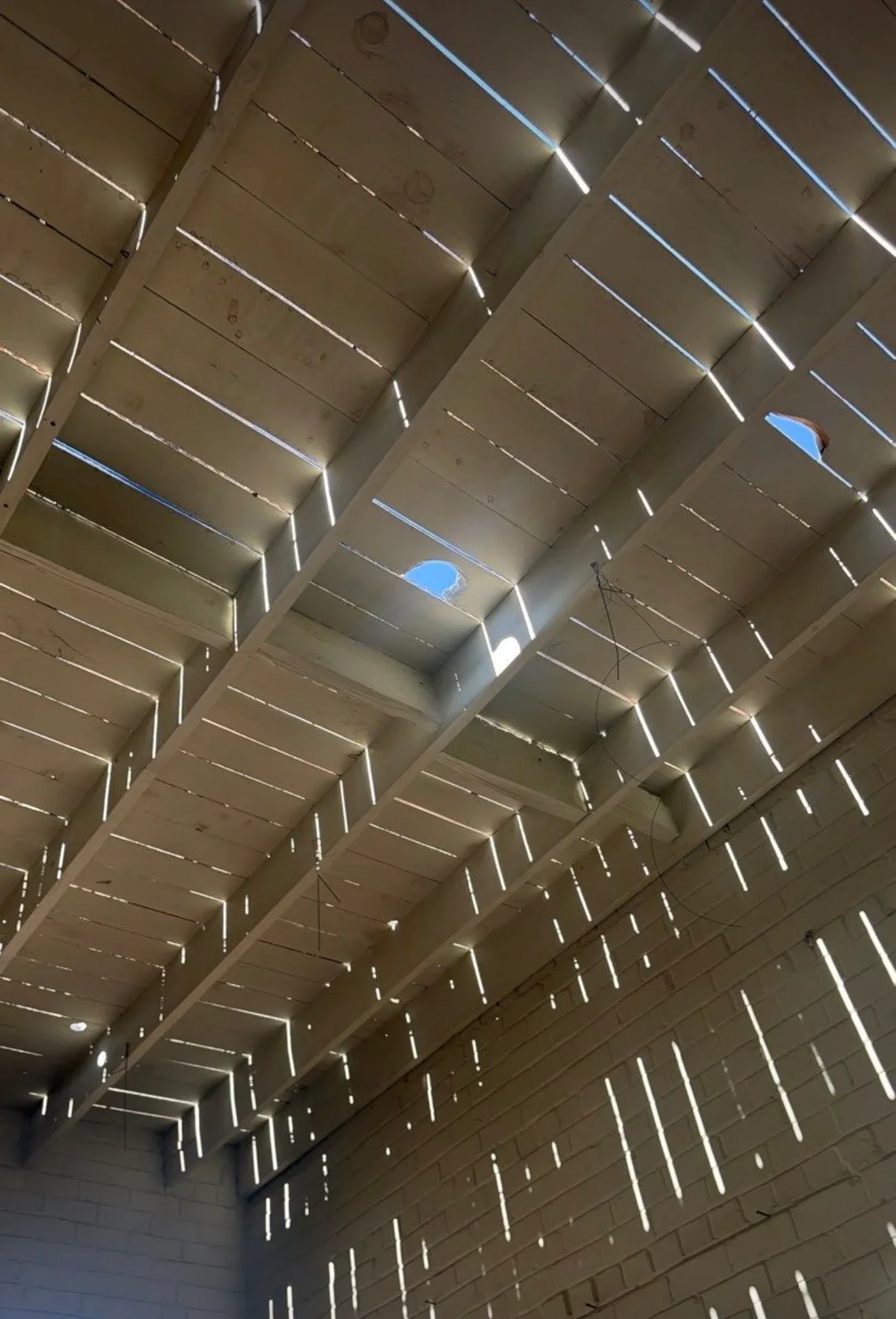 Aluminum soffit panels with integrated LED strip lighting and skylight openings