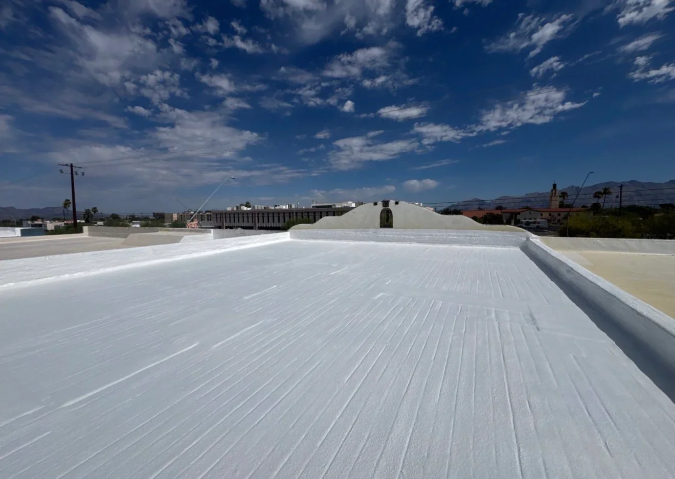 White TPO membrane flat roof with seam details and HVAC penetration on commercial building