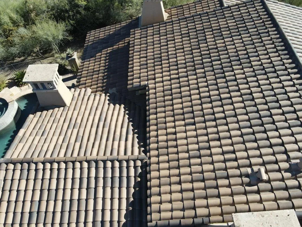 Spanish barrel tile roof installation with tan clay tiles on multiple roof planes