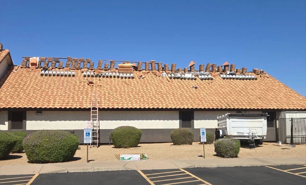 Clay tile roof with multiple brick chimneys and flue liners installed on commercial building