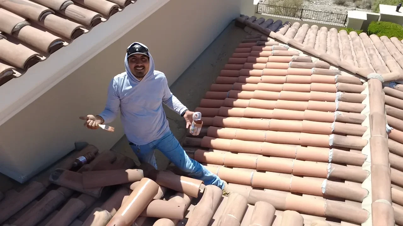 Clay barrel tile roof installation with terra cotta tiles and white mortar joints