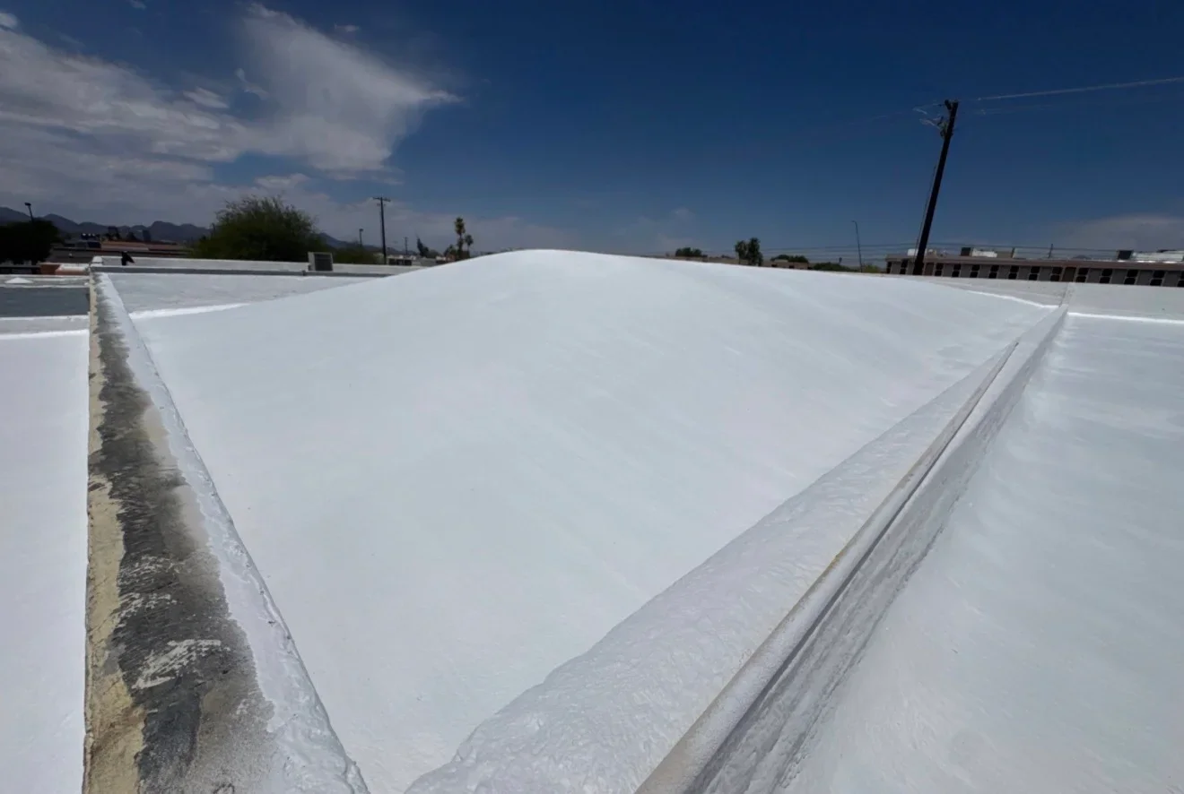 White membrane flat roof with seams and edge flashing on commercial building