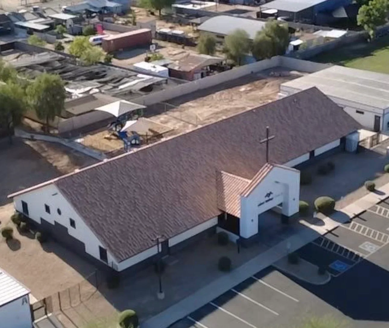 Aerial view of commercial building with new charcoal gray architectural shingle roof installation