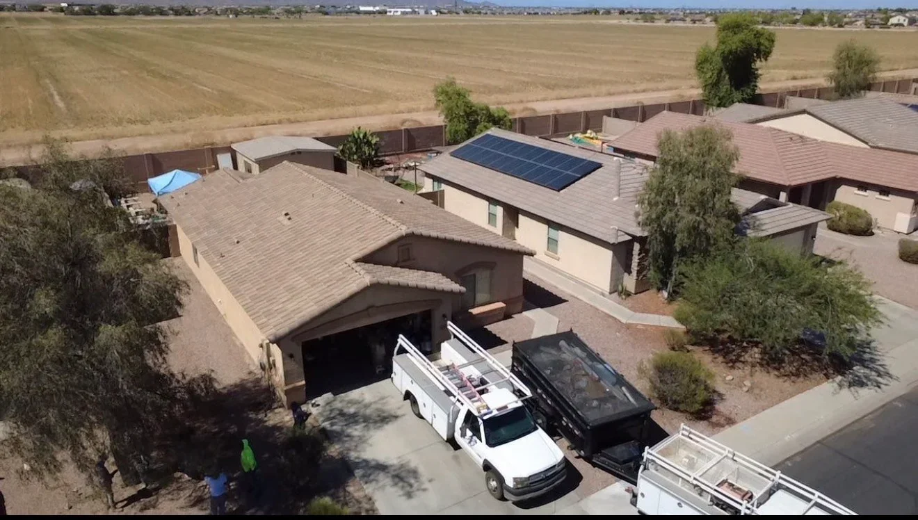 Clay tile roof with solar panels installed on residential home, aerial view