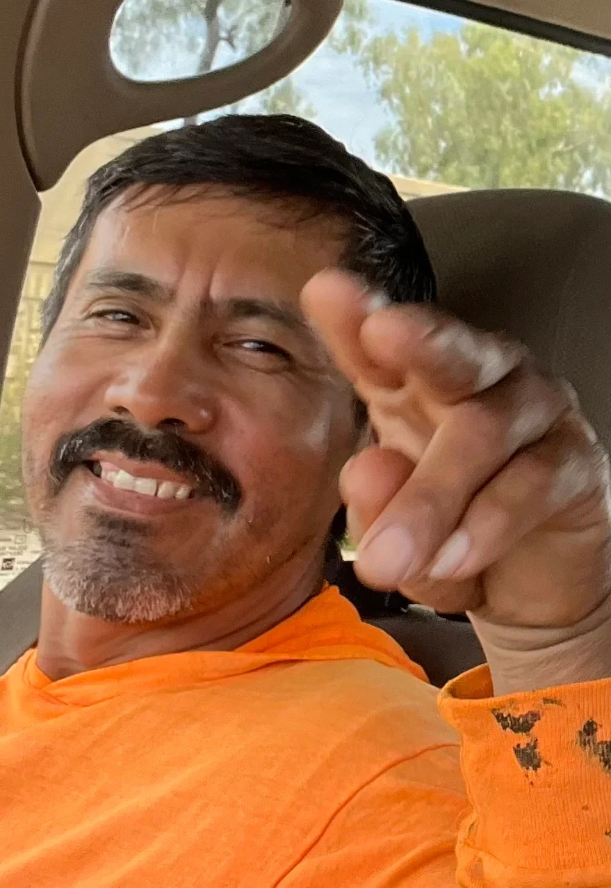 Roofing contractor in orange work shirt on job site