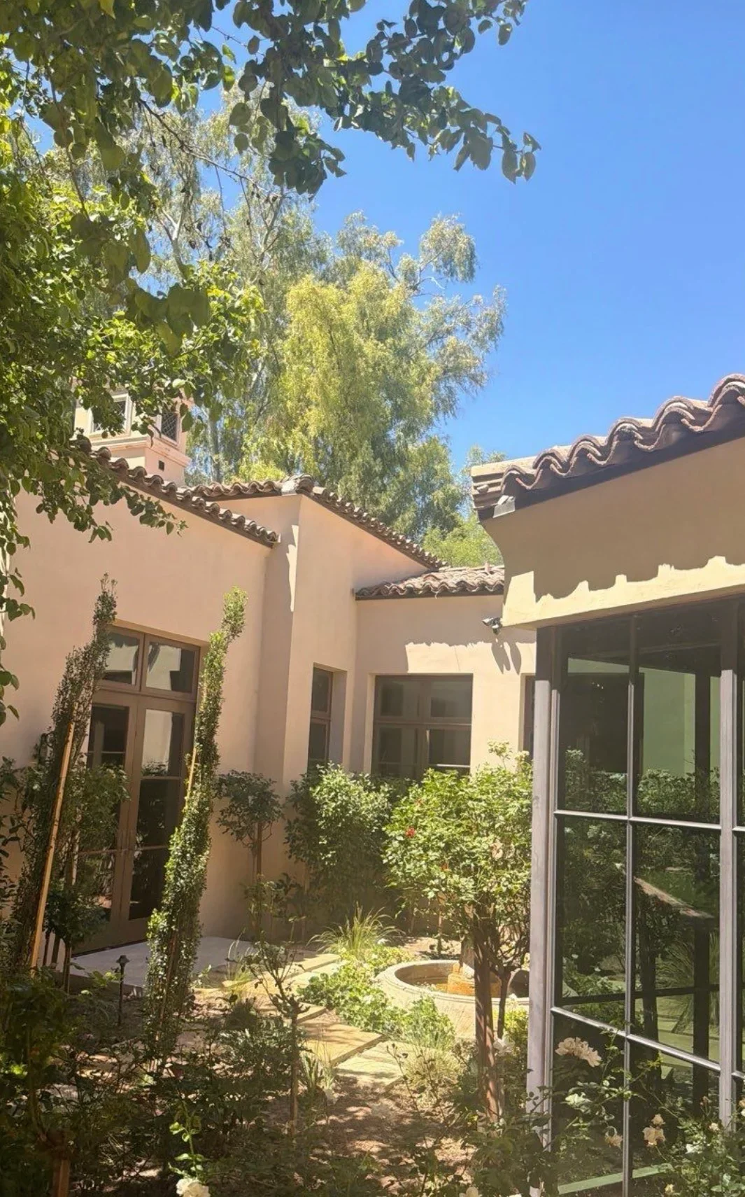 Spanish colonial roof with curved clay barrel tiles, white stucco walls, and courtyard setting
