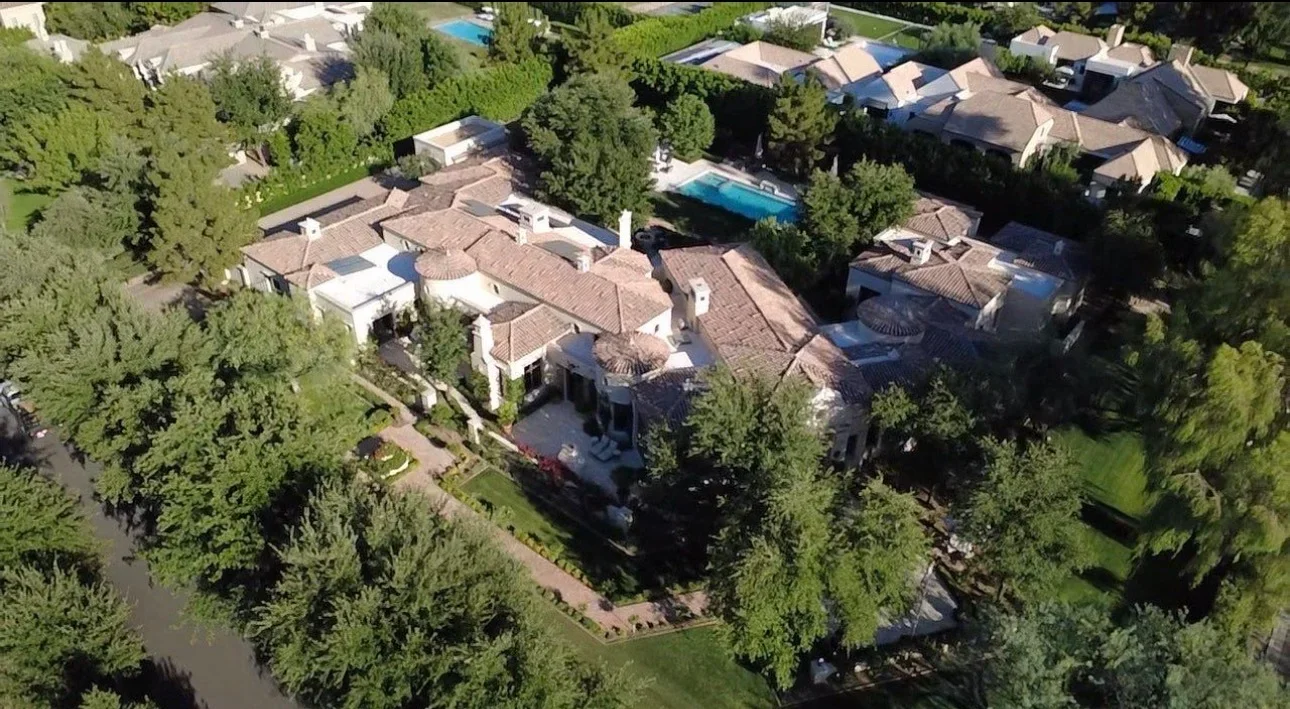 Aerial view of Mediterranean home with new clay tile roof installation, multiple roof planes and complex geometry